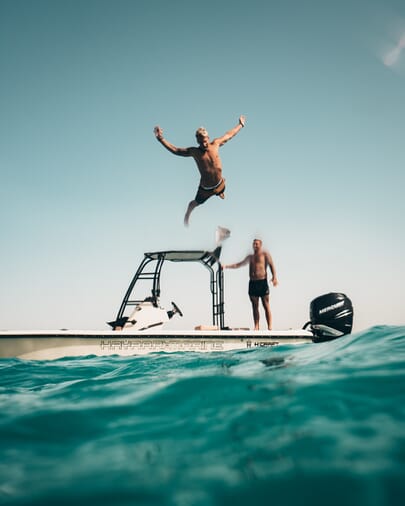 Diving high off of a moter boat
